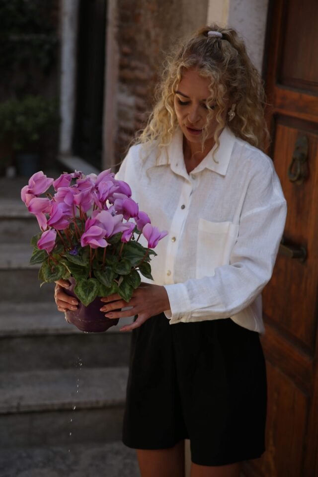 White linen shirt with black short and flowers