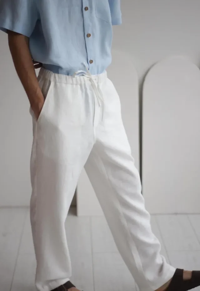 High-quality white linen pants FLORIDA with a classic design, featuring side pockets and a soft elastic waistband, perfect for summer casual wear.