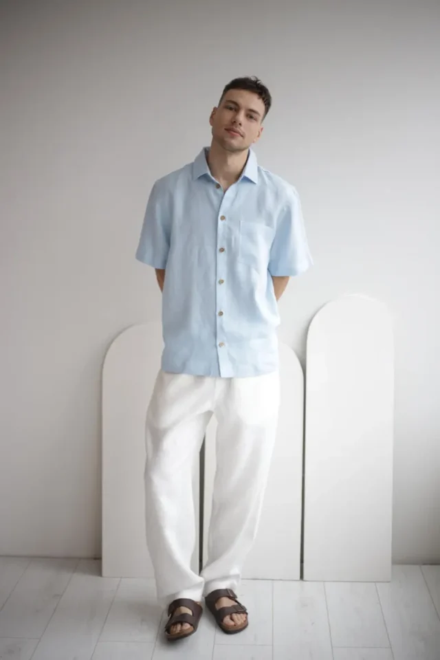 Man wearing FLORIDA white linen pants, showcasing a smart casual summer look, paired with a simple shirt.