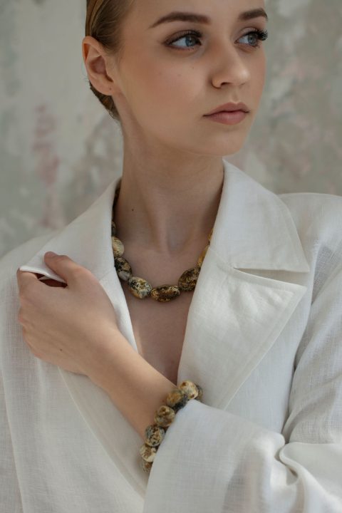 Handmade raw amber bracelet styled with elegant white linen clothing